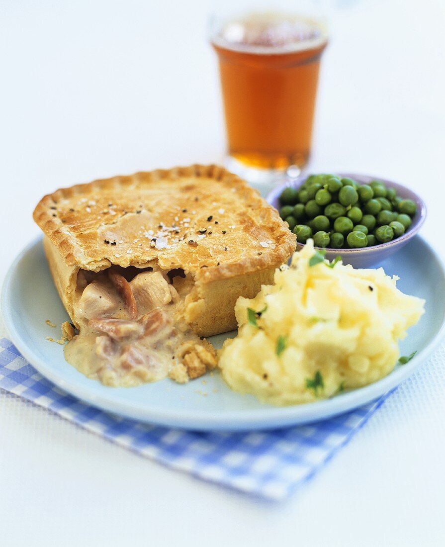 Chicken and ham pie with mashed potato and peas