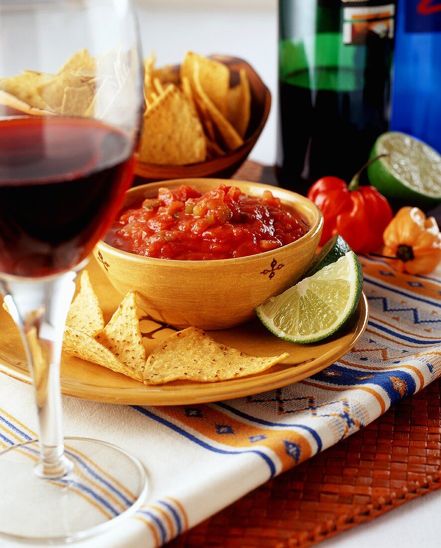 Tortilla chips with tomato salsa and red wine