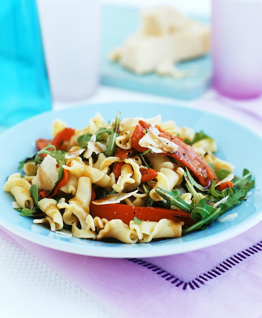 Mediterranean pasta salad with peppers, rocket and parmesan