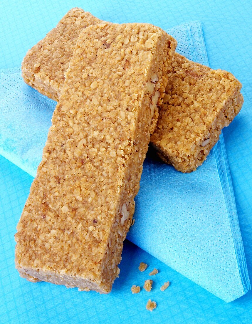 Two muesli bars on blue paper napkin