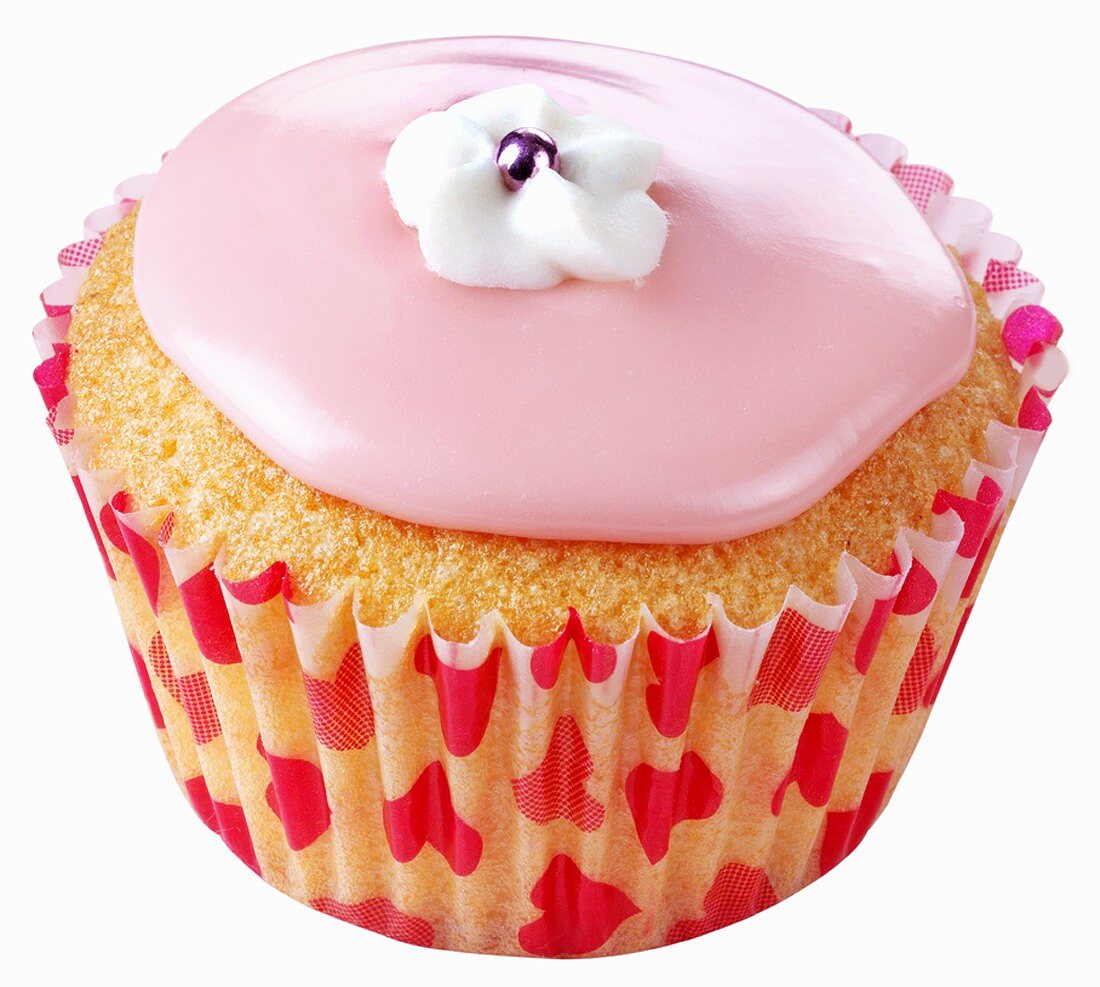 Cupcake with pink icing and white sugar flower