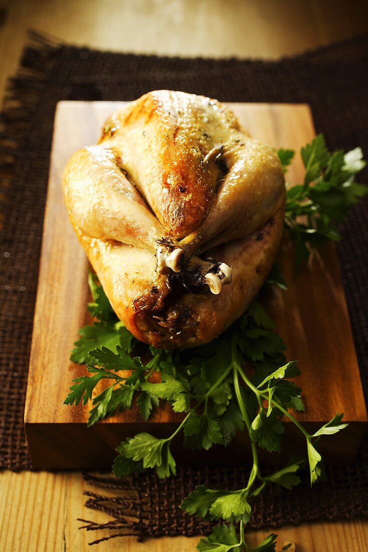 Roast guinea fowl on chopping board