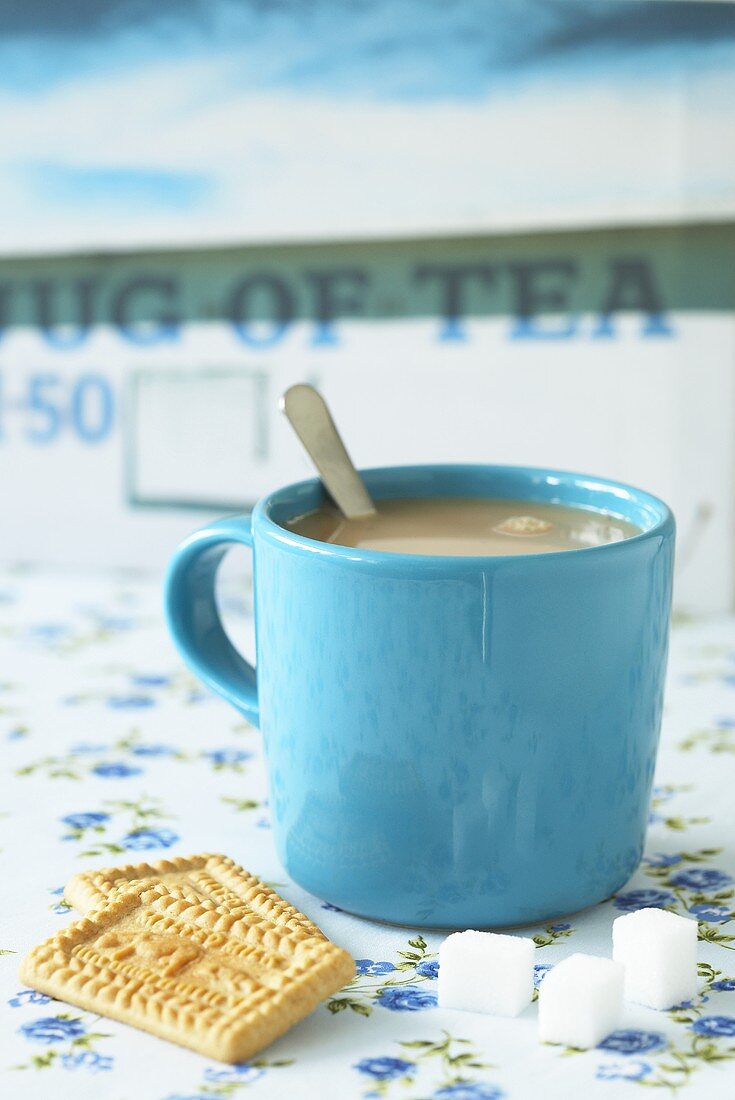 Mug of tea, malted milk biscuits and sugar cubes (UK)