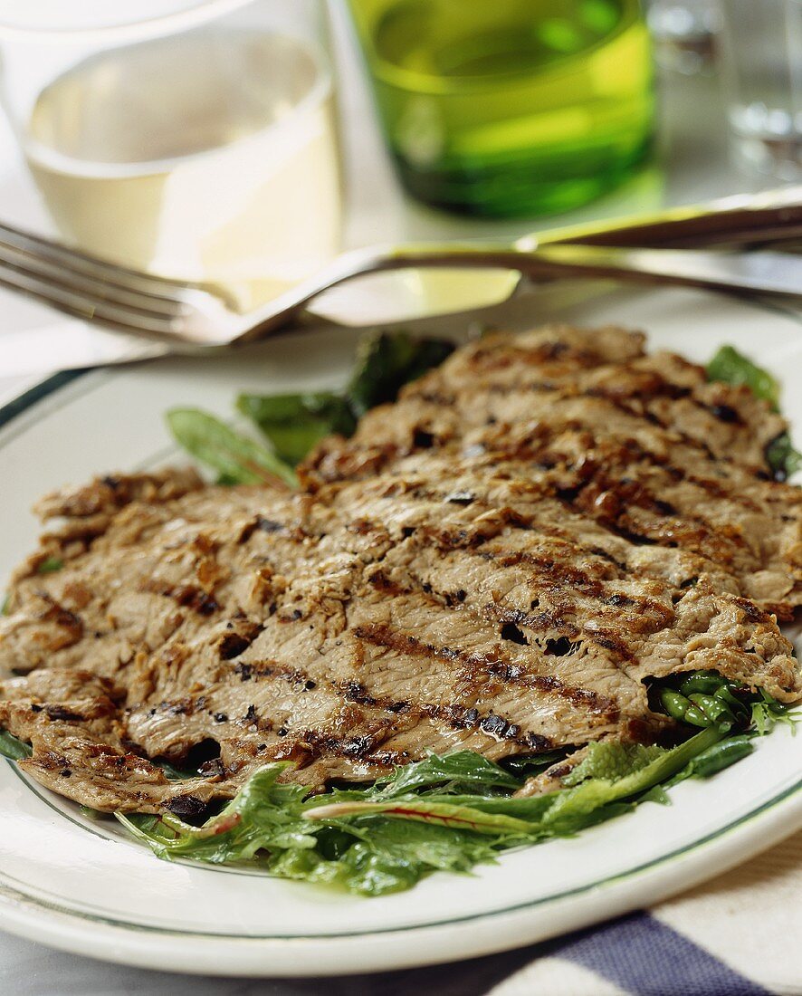 Grilled minute steak on a bed of salad