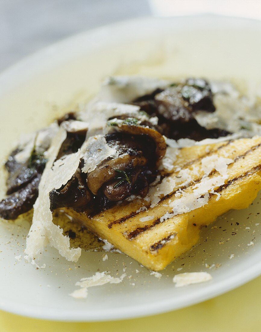 Grilled polenta slices with mushrooms and Parmesan