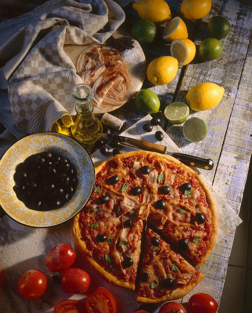Pizza mit Schinken und schwarzen Oliven