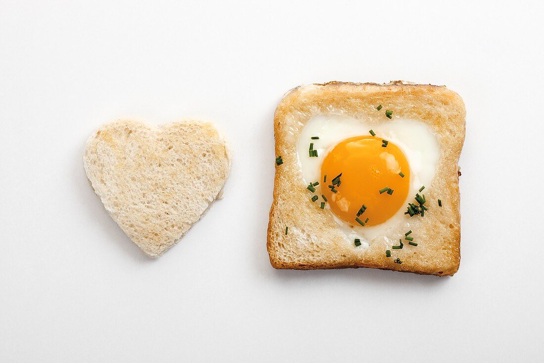 Egg in toast (or egg in the basket) with heart-shaped toast