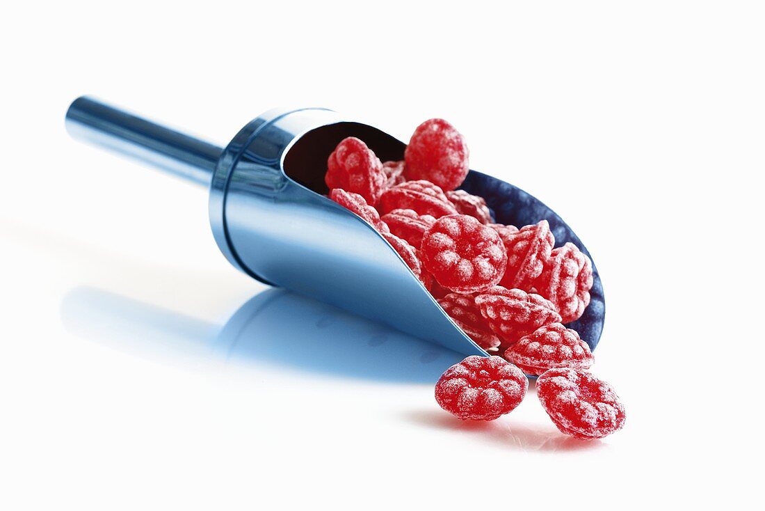 Raspberry sweets in metal scoop