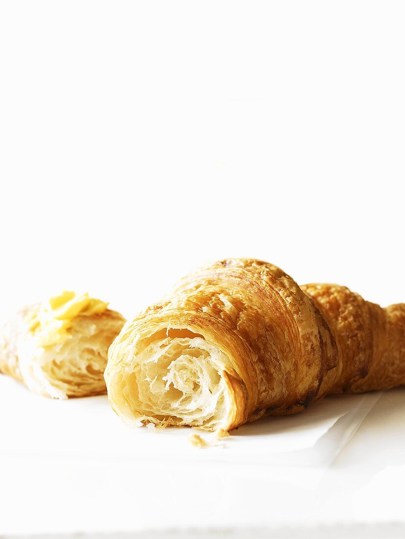 Croissant, broken, with butter