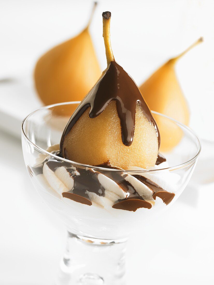 Poached pear with chocolate sauce and cream