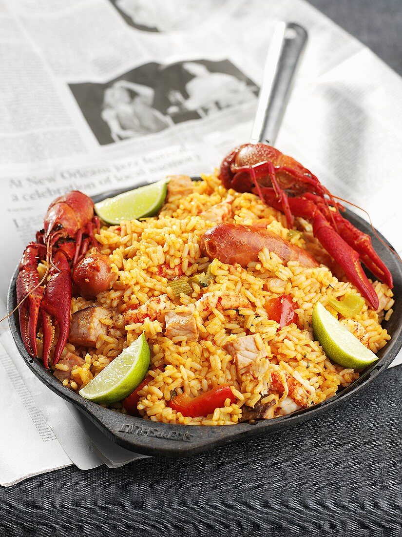 Paella in frying pan on a newspaper