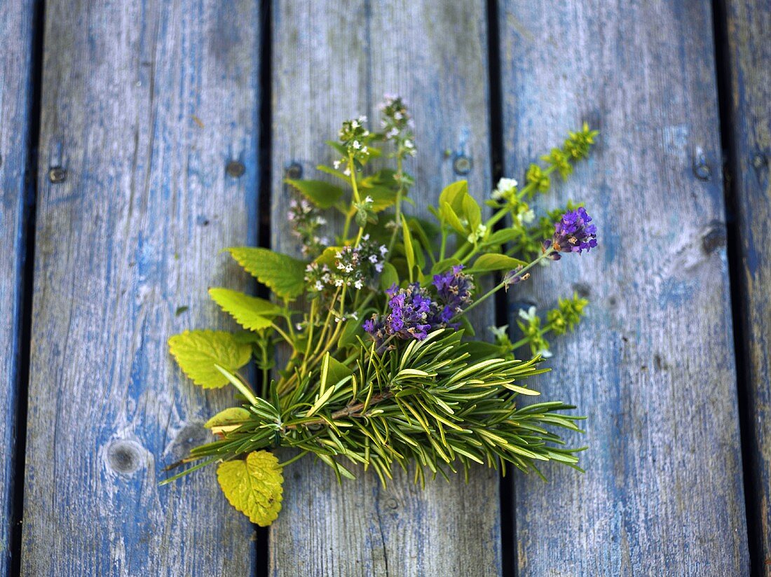 Small bunch of herbs on wooden boards