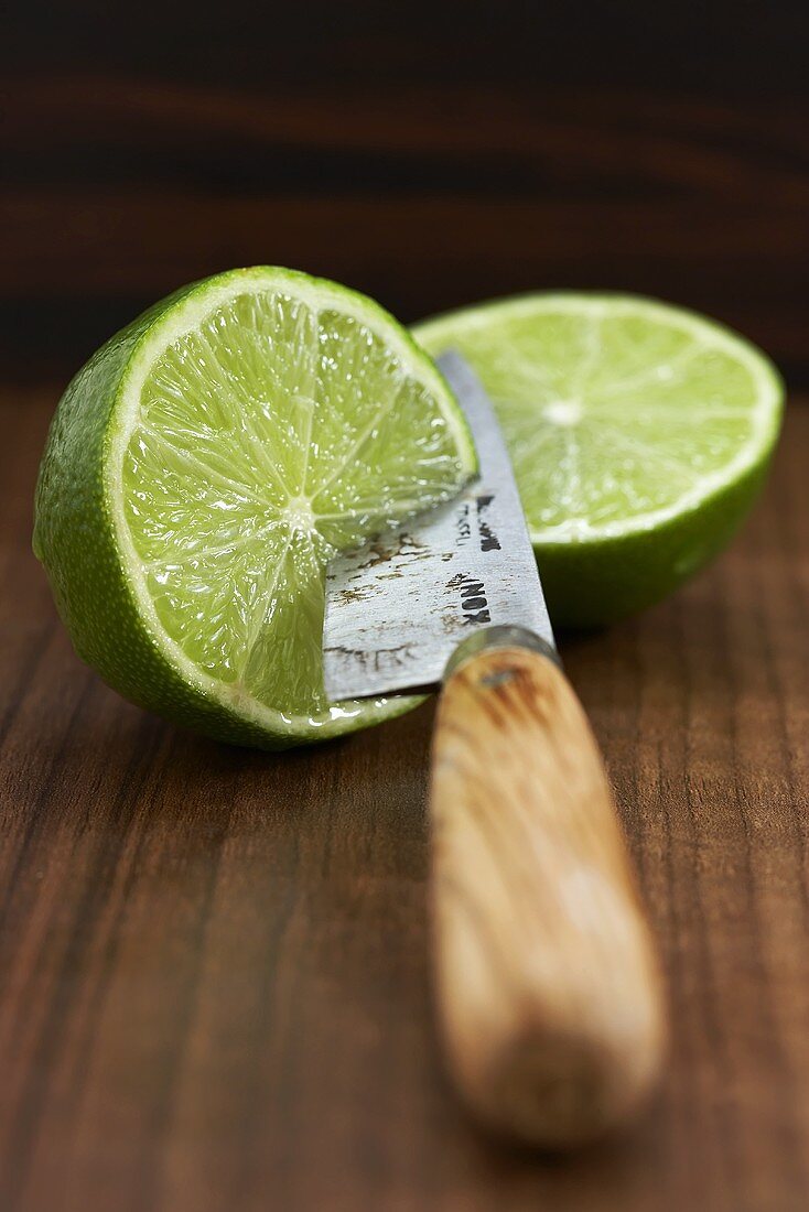 Two lime halves with knife
