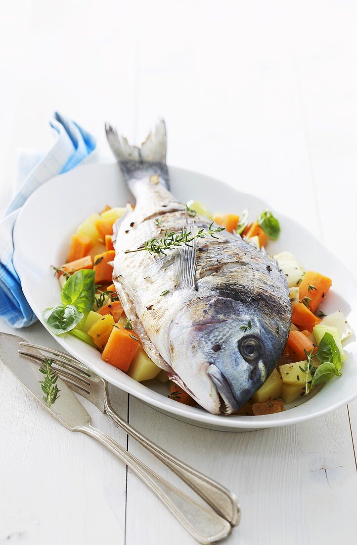 Roasted sea bream on a bed of vegetables