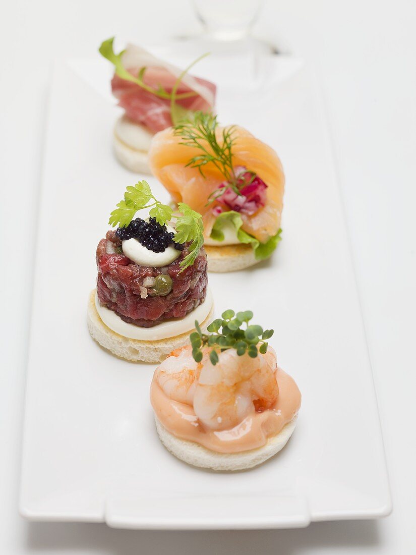 Assorted canapés with prawns, fish and prosciutto