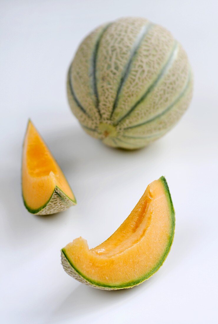 Whole cantaloupe melon and two slices