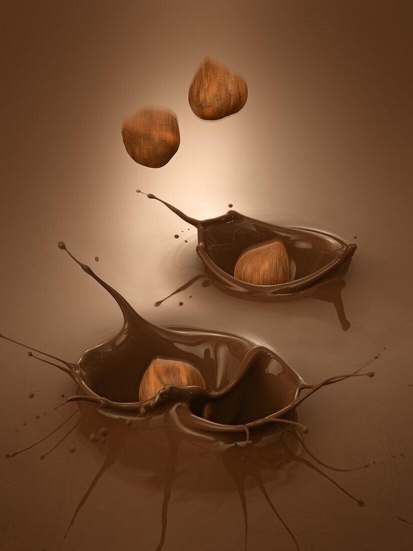Haselnüsse fallen in flüssige Schokolade