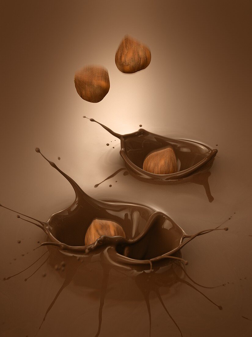 Hazelnuts falling into melted chocolate