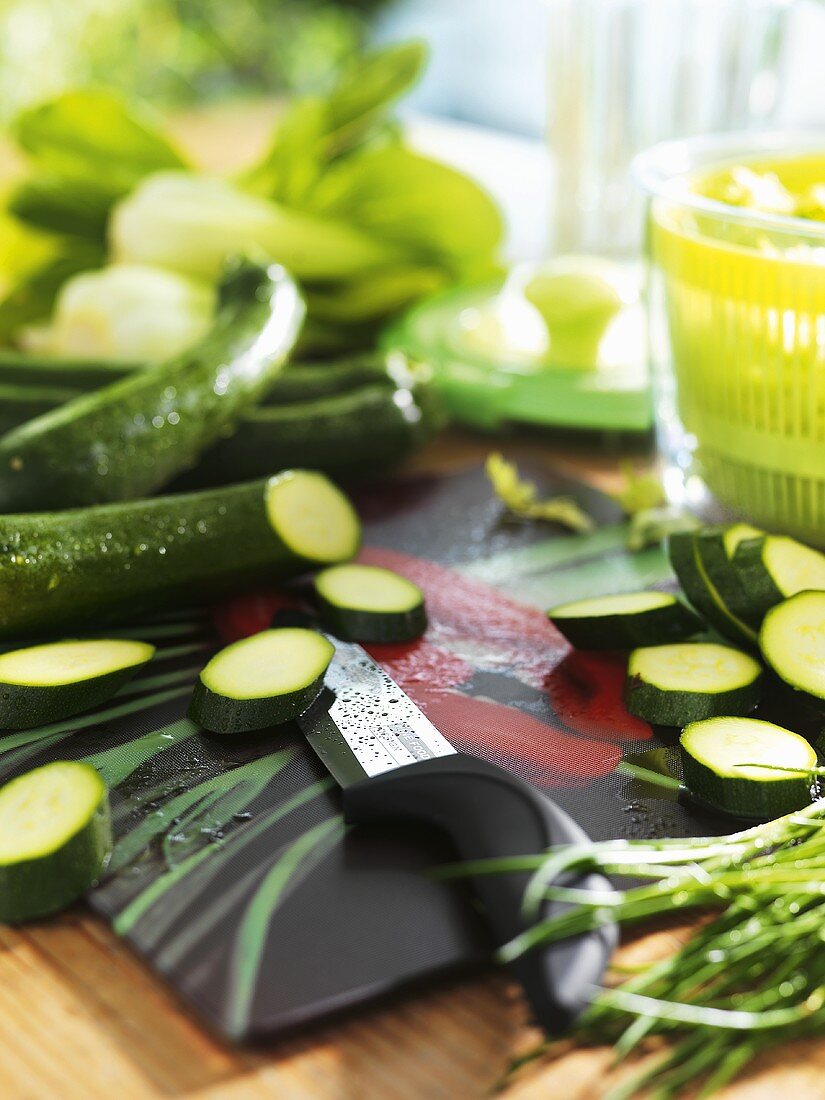 Kitchen scene with partly sliced courgettes