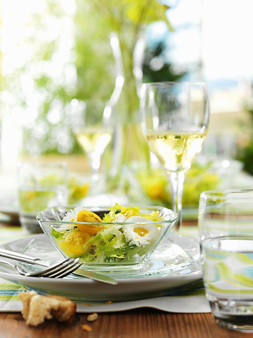 Frisee salad with daisies and yellow tomatoes