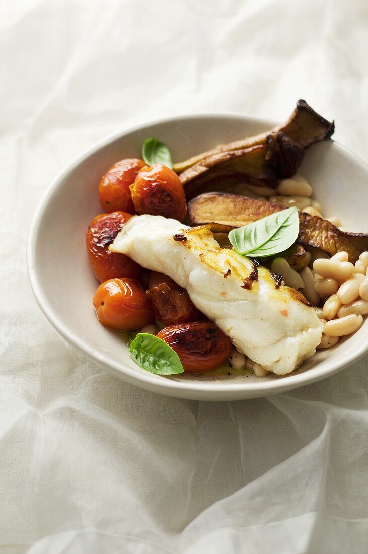 Fried fish fillet with tomatoes, beans and aubergines