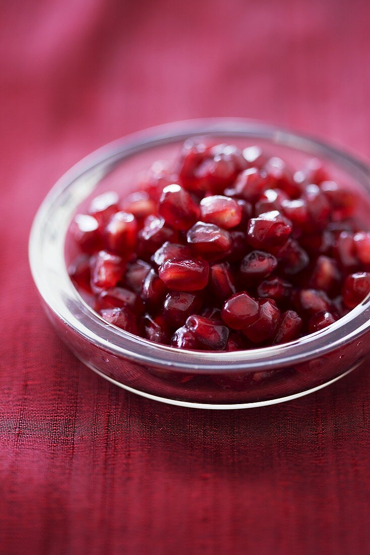 Pomegranate seeds in glass dish
