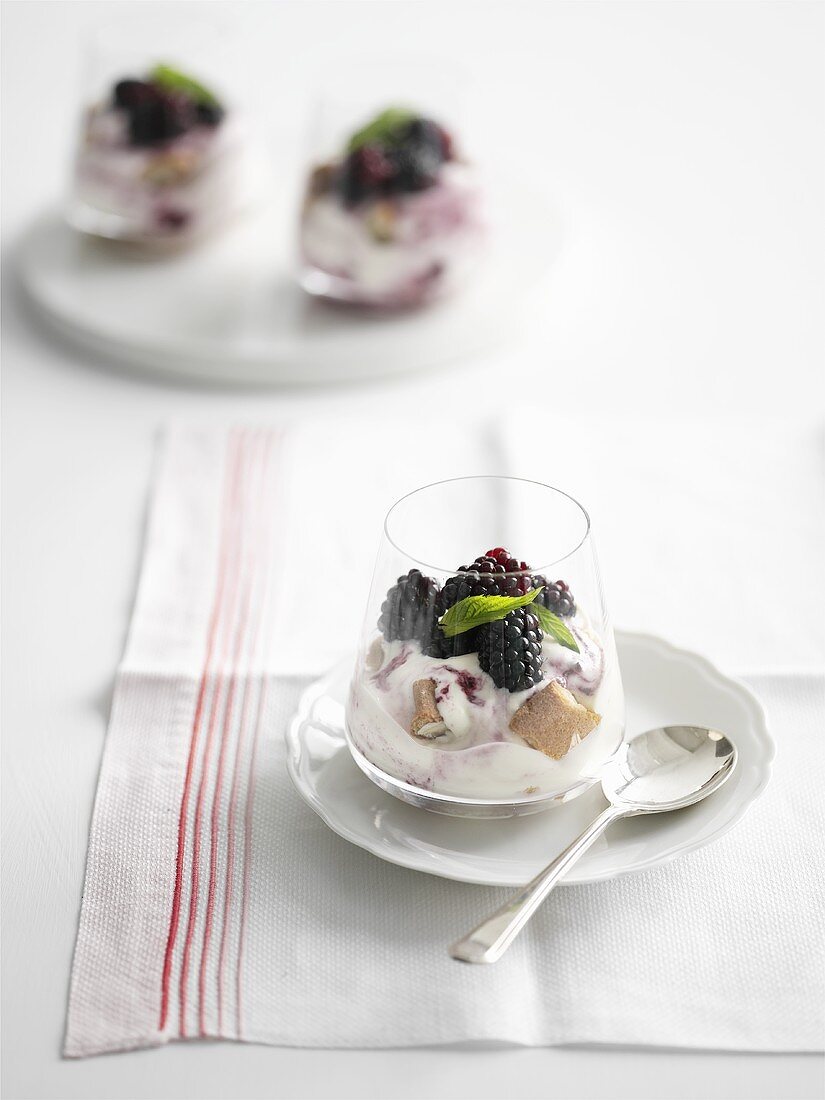 Yoghurt cream with blackberries in glass