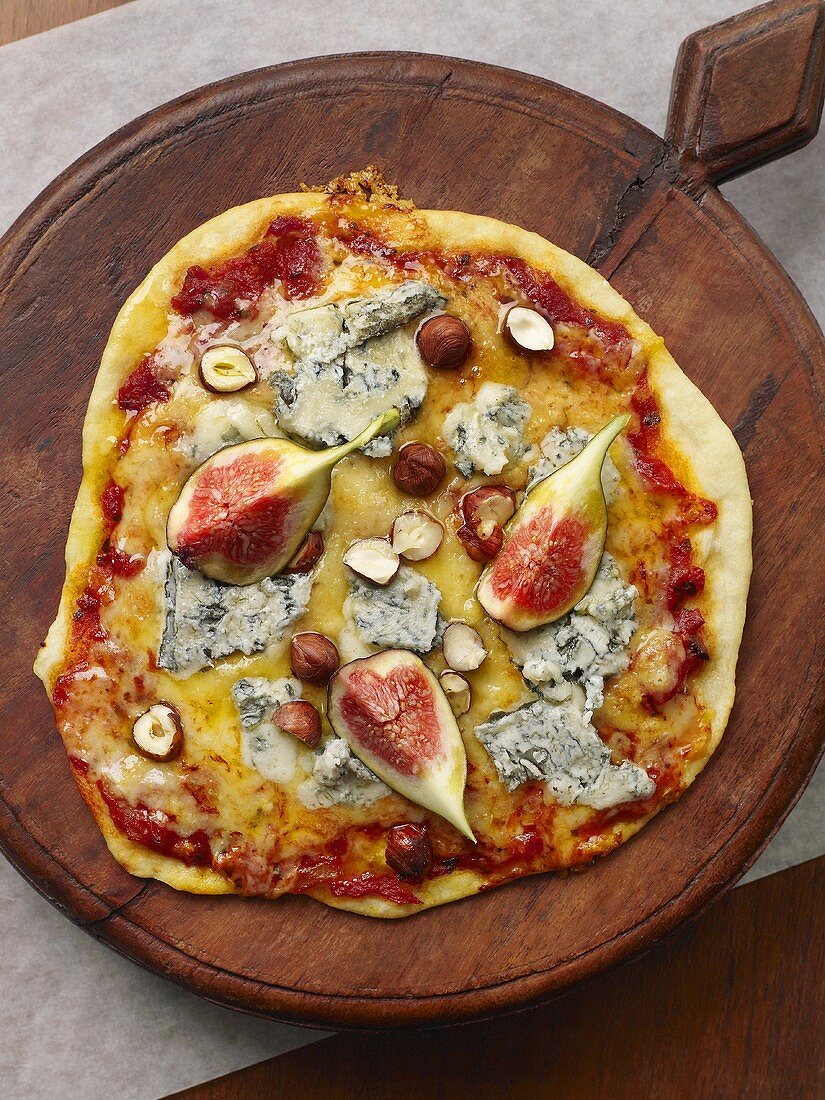 Pizza topped with Gorgonzola, figs and hazelnuts