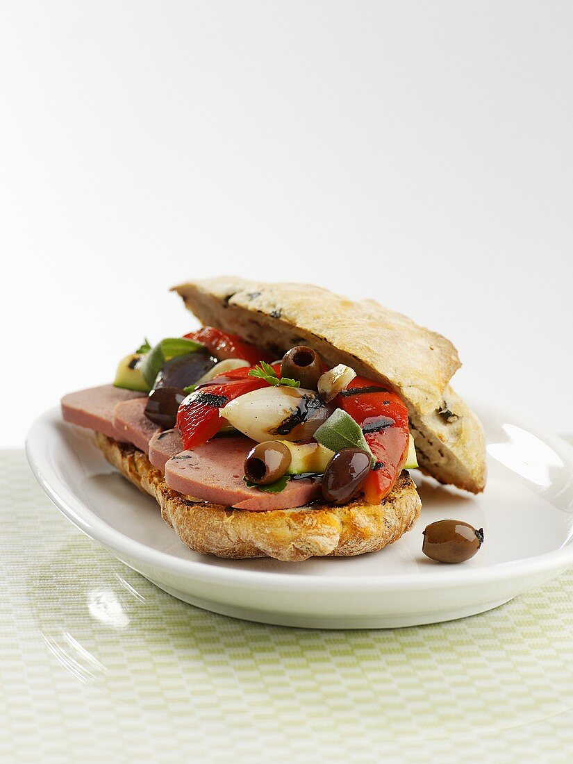 Ciabatta filled with sausage, grilled vegetables & olives