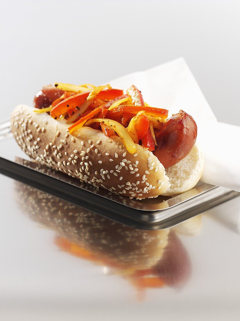 Hot dog with red pepper in sesame bun
