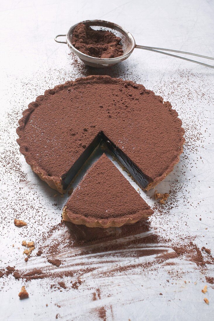 Chocolate tart dusted with cocoa powder