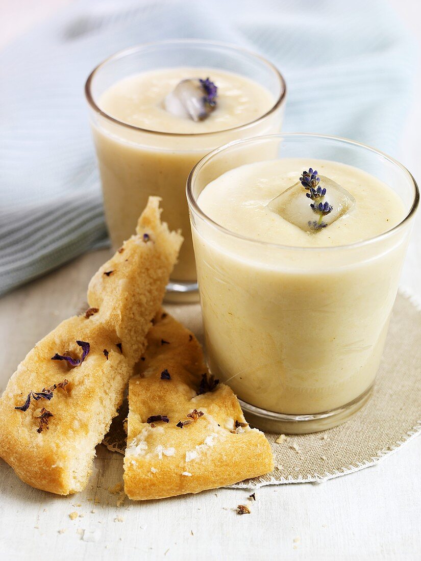 Cold vichyssoise in glass with ice cubes and flatbread