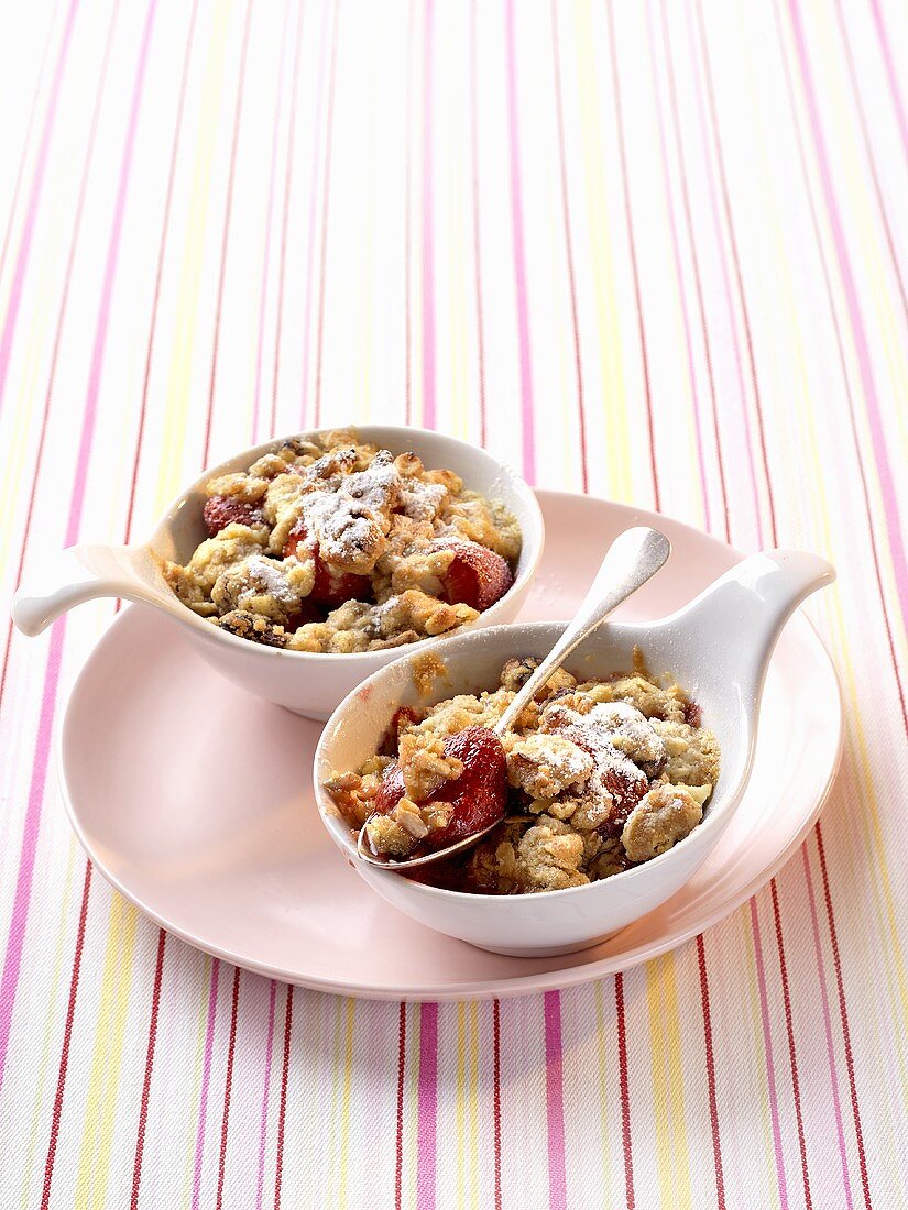 Two individual portions of strawberry muesli crumble