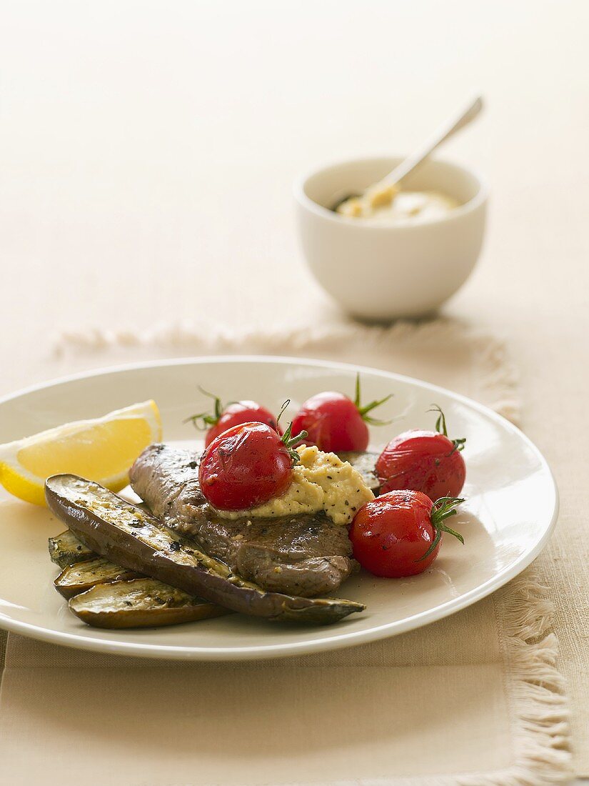 Lamb with aubergines, tomatoes and hummus