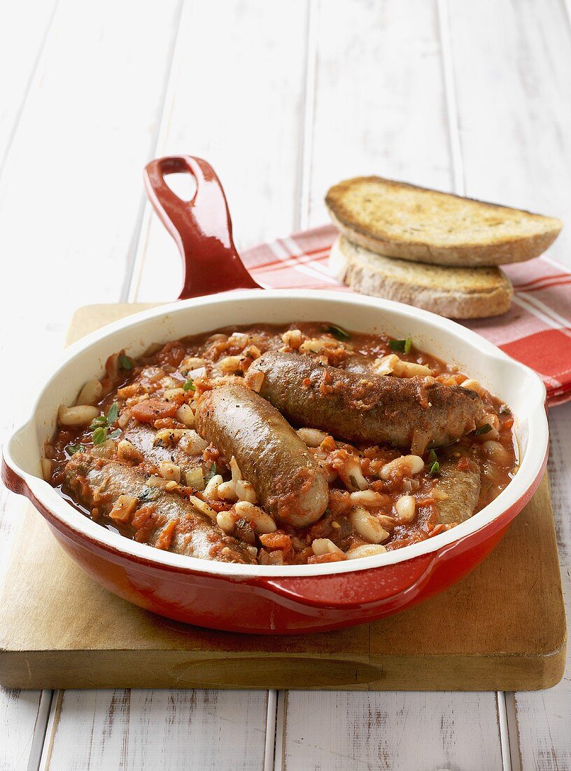 Baked beans and sausages in frying pan