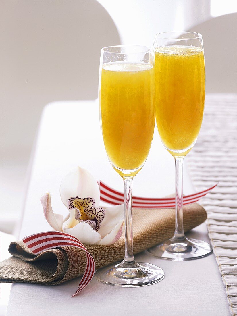 Two Bellinis (cocktail made with sparkling wine)