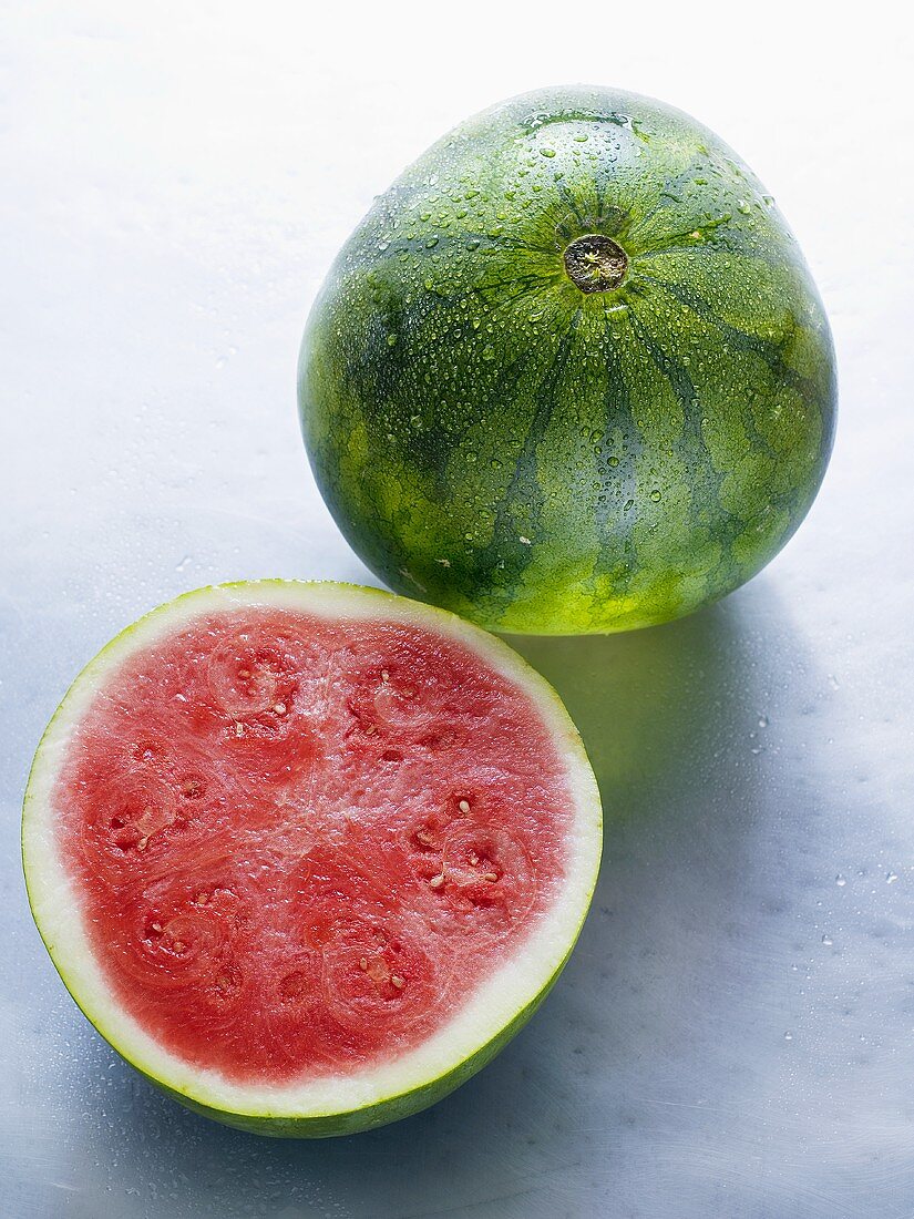 Whole watermelon and half a watermelon