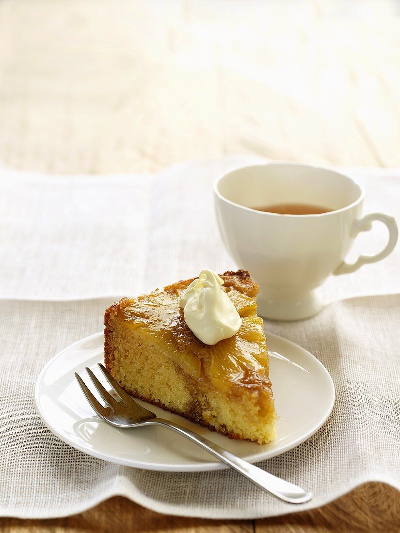A piece of pineapple honey cake with a cup of tea