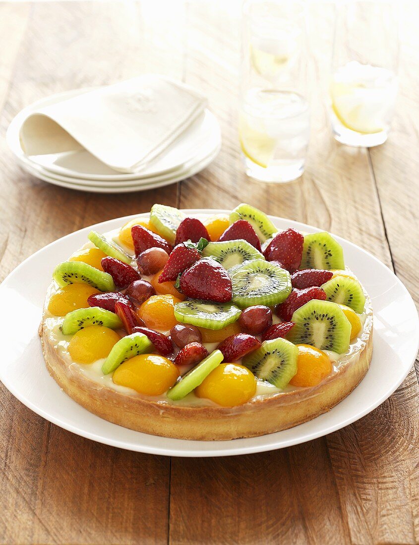 Fruit flan with apricots, kiwi fruit, strawberries & grapes