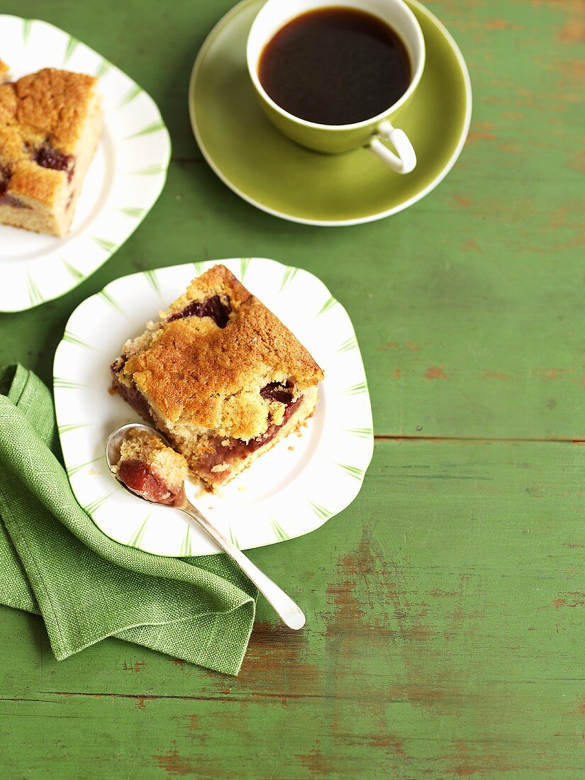 Two pieces of plum cake with a cup of coffee