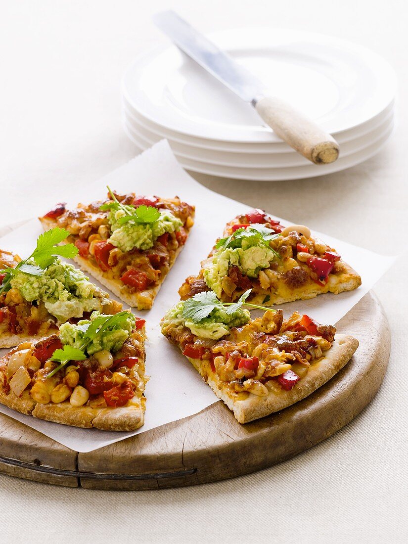 Pizzastücke mit Mais, Paprika und Guacamole