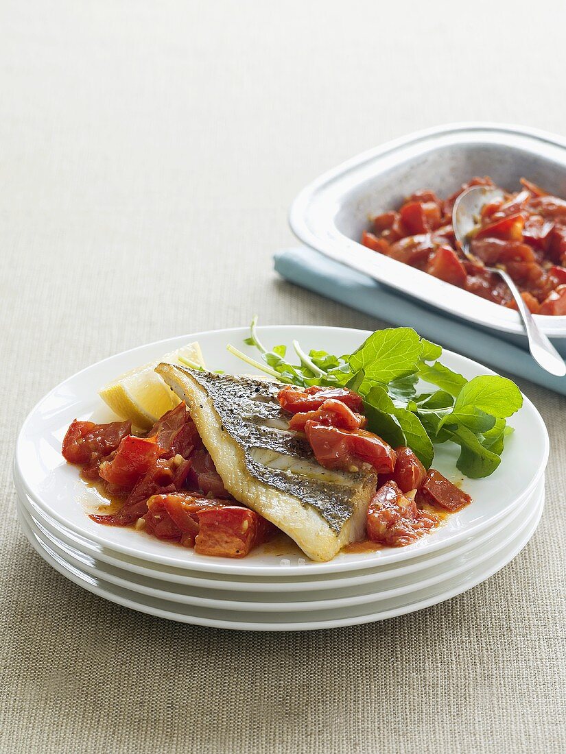 Fish fillet with garlic and roasted tomatoes