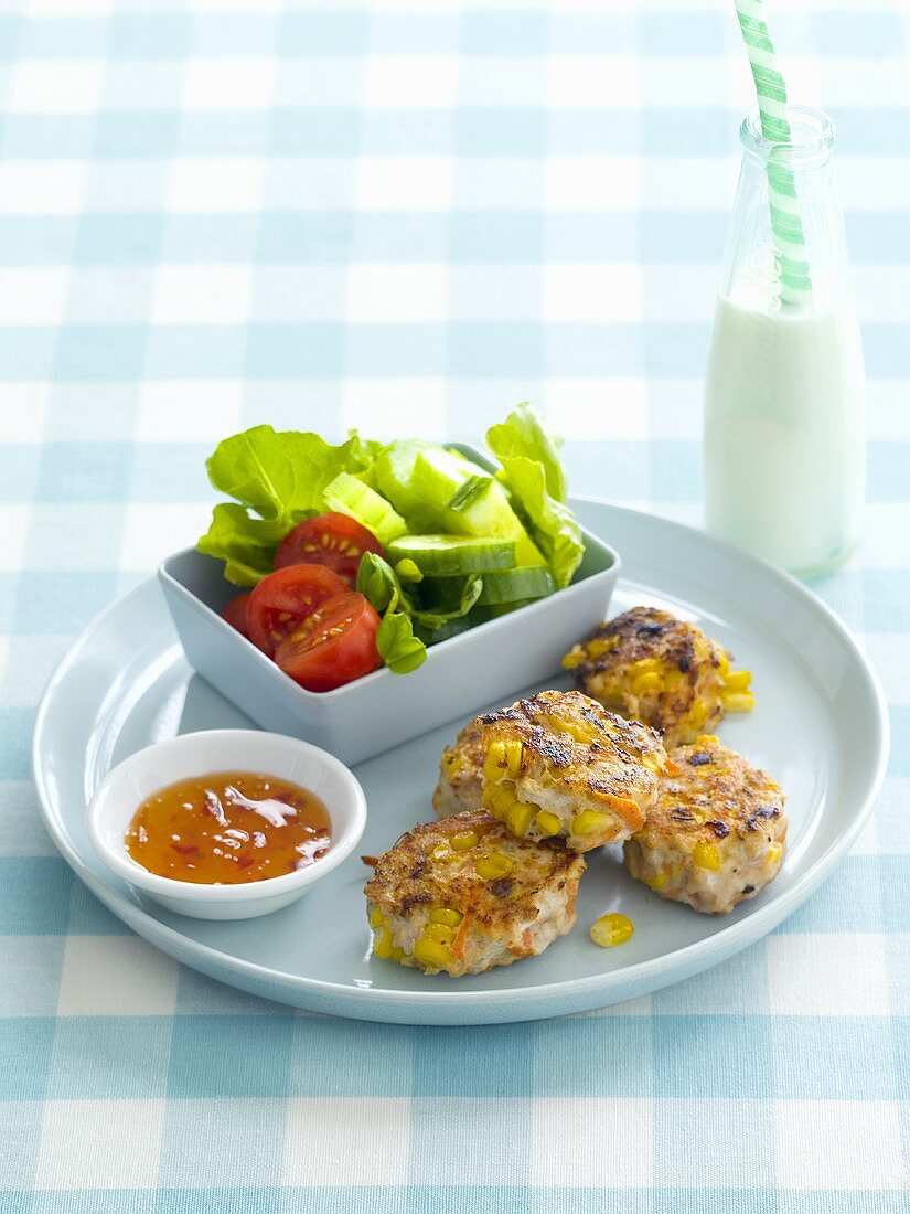 Chicken and sweetcorn cakes with salad and chilli sauce
