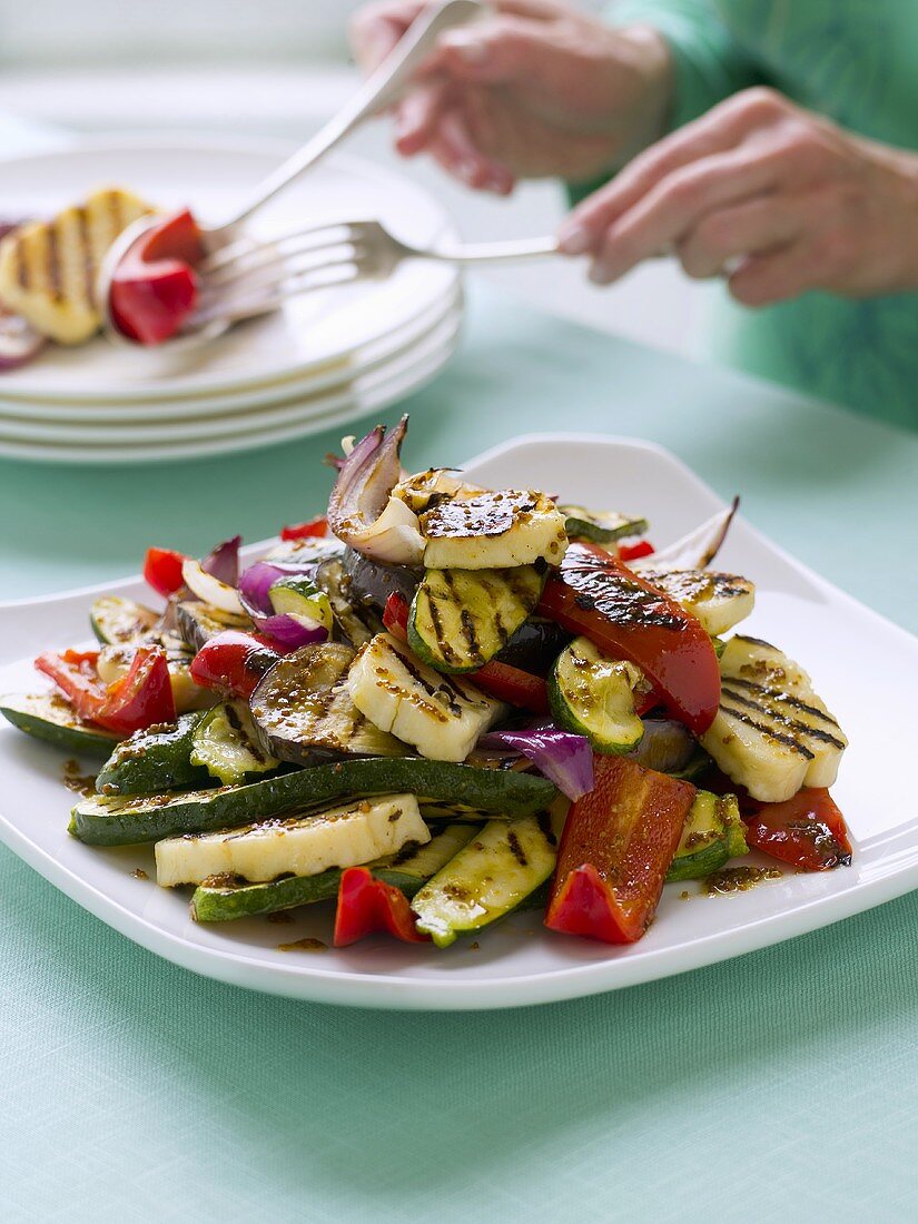 Grilled vegetables, person in background