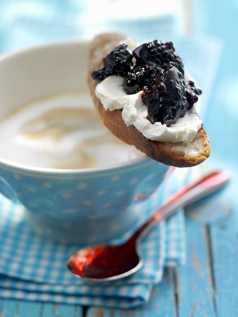 Bread with soft cheese & blackberry & elderberry jam on cup