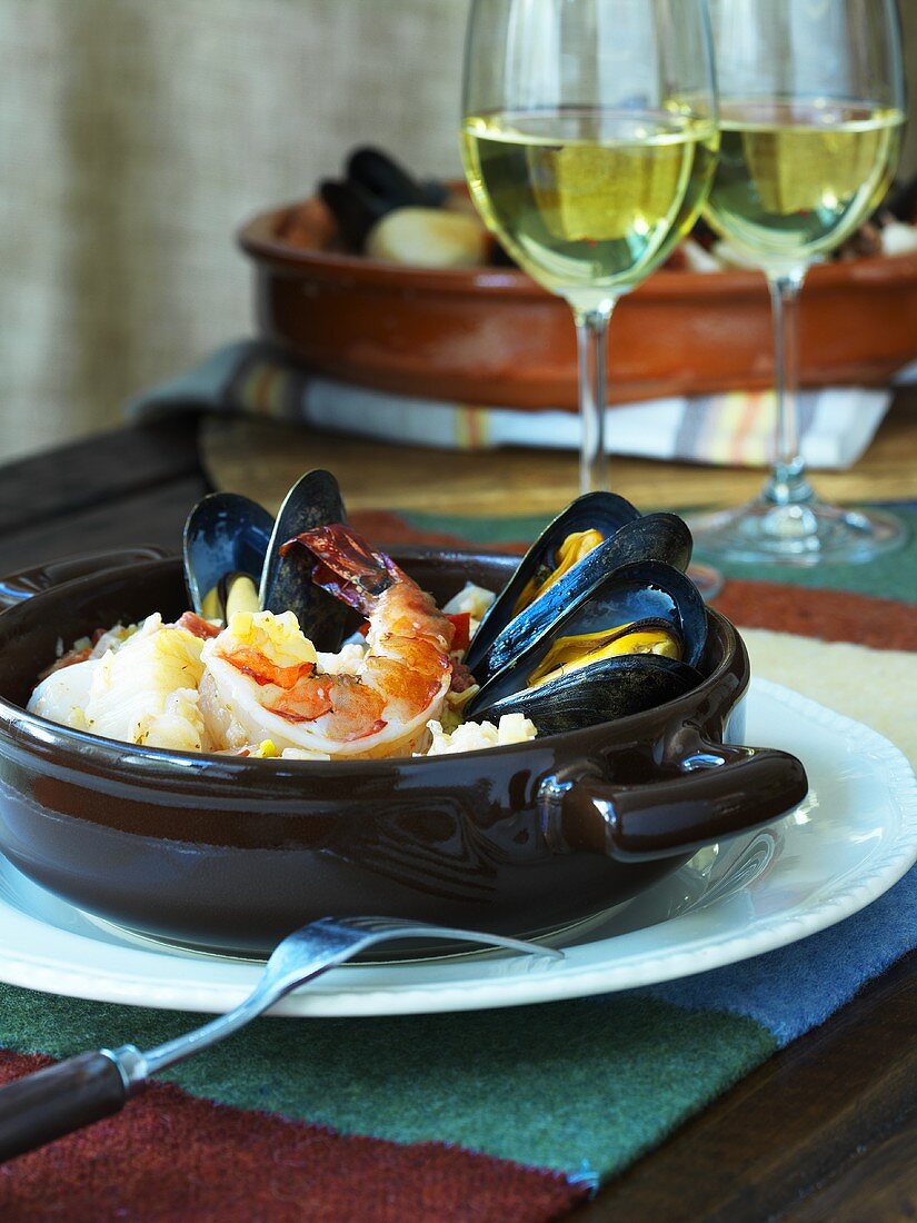 Seafood stew and two glasses of white wine