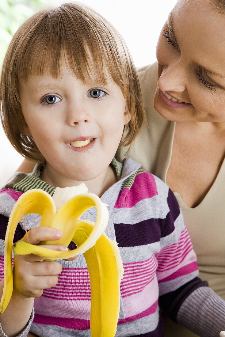 Kleines Mädchen isst eine Banane