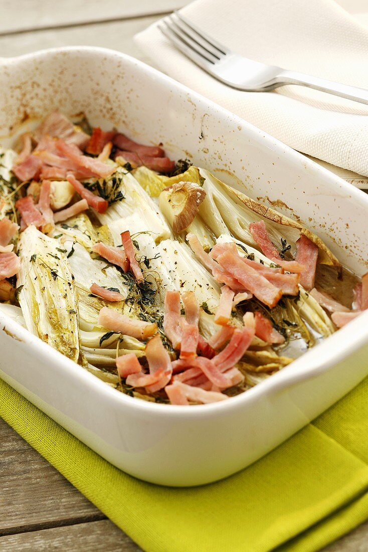 Chicory with ham, garlic and thyme in baking dish