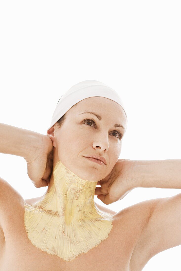 Woman with facial mask on neck and upper chest