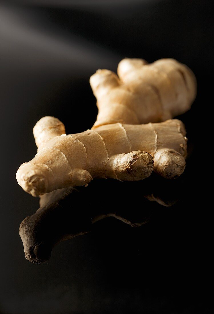 Ginger root on reflective surface